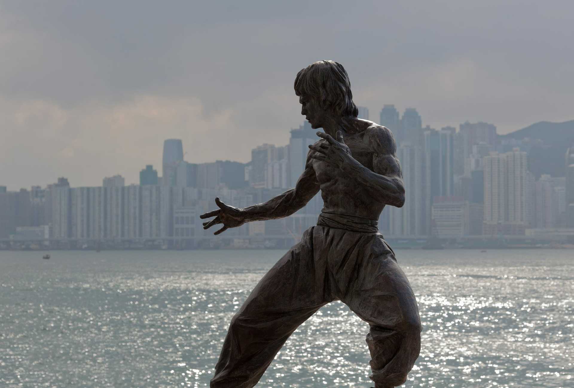 Bruce Lee statue in front of body of water Hong Kong technology flexibility
